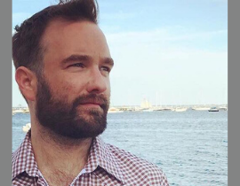  Joseph Donohue III stands near the water.